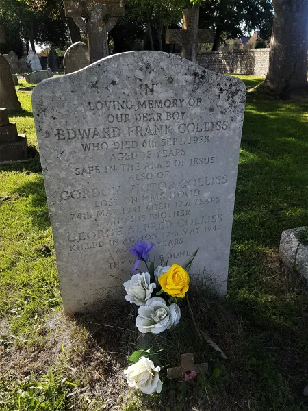 Gravestone with flowers placed at its foot.