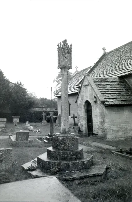 Cross stood beside church.