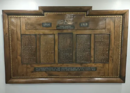 Rectangular wood board with brass trim and inscribed names