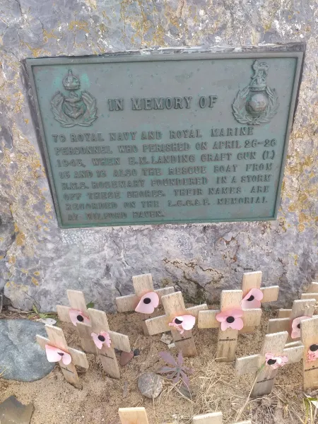 Bronze plaque with commemorative inscription on stone.