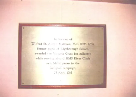 Brass plaque on wooden board