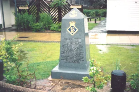 Polished gray stone obelisk with dedicatory inscription