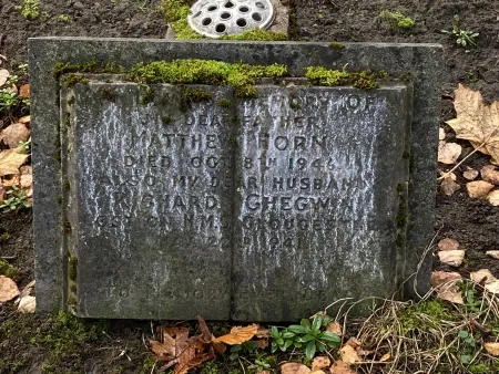 Stone family gravestone shaped like an open book