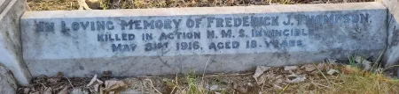 A family kerbed grave with the name of the remembered inscribed on one of the kerbs.