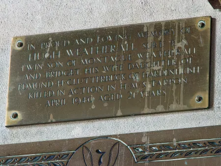 Rectangular brass plaque with incised lettering.