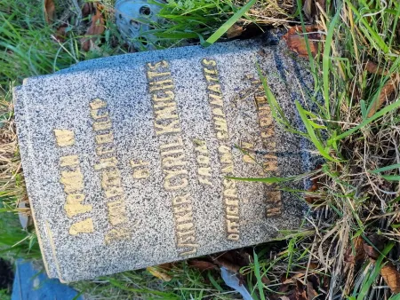 A marble vase withing a kerbed grave