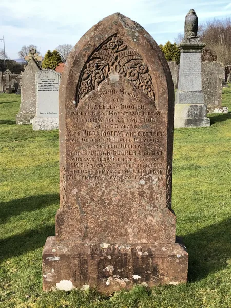 Gothic shaped red stone gravestone