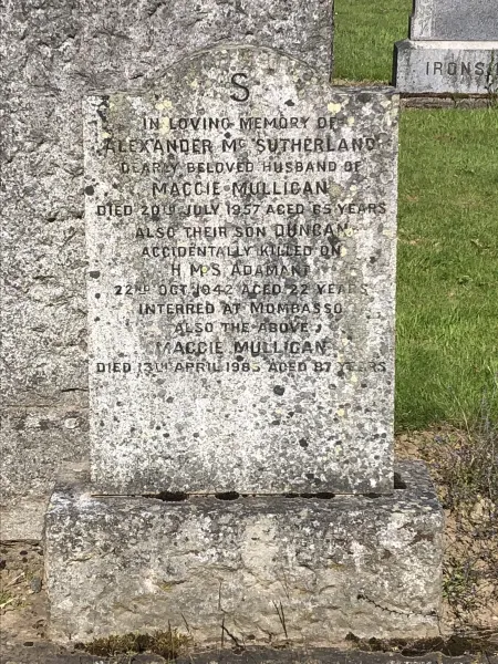 Short granite gravestone with rounded top with shoulders