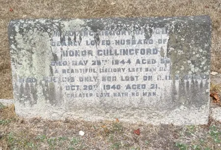 A kerbed grave with a granite gravestone with a flat top and one name in addition to that remembered