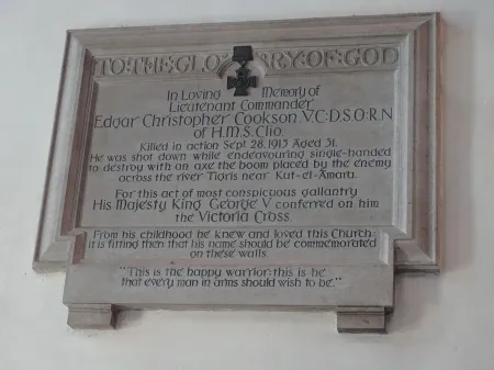 The memorial plaque to Lt Cmd E C Cookson VC on the South wall of the nave of the church of St Candida and Holy Cross Whitchurch Canonicorum