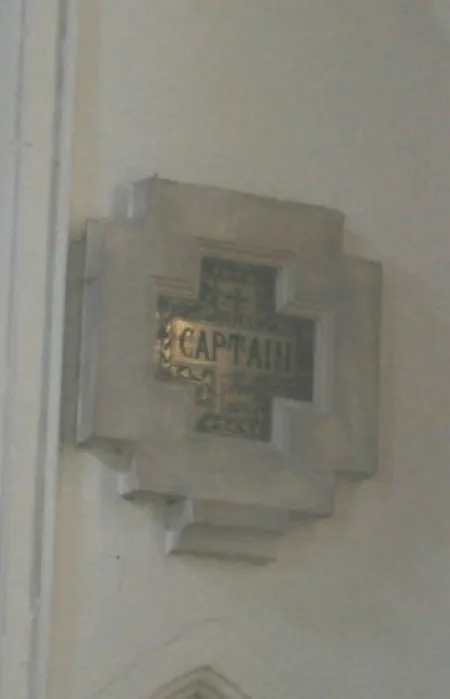 Memorial in shape of stone cross with central brass cross