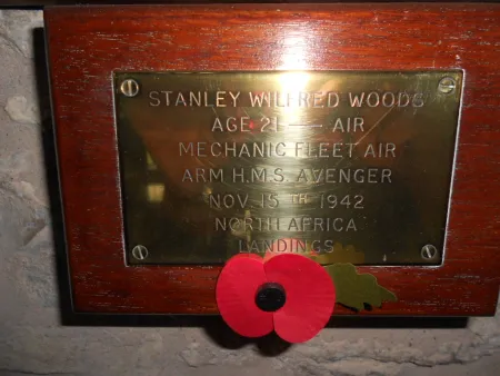 Brass plaque on a wooden backboard 
