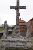 Elaborate life-sized stone calvary depicting Christ crucified, watched by three figures.