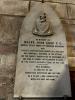 Curved stone tablet with lettering in black 