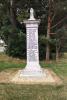 Seated lion set on a tall square column and three stepped base. The inscription and names are in black lettering on each side of the column.