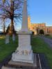 Foundation platform supporting a four-stepped square base surmounted by a square sectioned plinth, pedimented capstone and tapering square sectioned obelisk. Incised inscriptions and names in black paint on plinth and certain step faces.