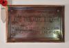 Close up of rectangular brass plaque.