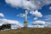 Hilltop memorial with trees and trig point alongside