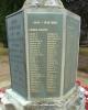 Tall cross with a sword of sacrifice standing on an octagonal plinth and four stepped octagonal base. The names on the slate tablets are picked out in gold lettering.