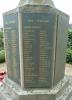 Tall cross with a sword of sacrifice standing on an octagonal plinth and four stepped octagonal base. The names on the slate tablets are picked out in gold lettering.