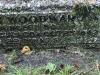 Base of gravestone with lettering.