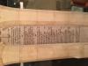 White stone pillar niche with inscribed names in black ink.
