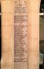 White stone pillar niche with inscribed names in black ink.