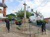 Cross on plinth and step base, surrounded by railings