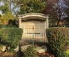 Portico with hedge and railings in foreground