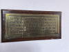 Brass plaque beneath window