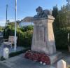 Lion figure on plinth with poppy wreaths at base