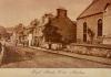Historic image of high street and memorial.