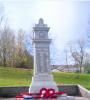 Memorial with wreaths laid at its base.