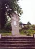 Vertically standing stone with steps leading up to it.