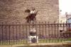 Metal statue of angel holding grain.