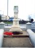 Memorial with wreaths laid at its base.