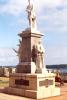 Stone statues of soldiers and sailors on a plinth.
