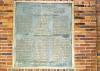 Plaque on brick wall.
