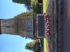 Sandstone Cenotaph standing on a 3 step base with a wreath in half relief at the top. Underneath there is a black marble name plaque incised with gilded lettering to those who fell in WW2. Lower name plaque made of copper with raised lettering has the names of the fallen in WW1 with surnames in alphabetical order from A to L 