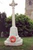 Cross with wreath laid at its base.