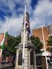 Figure of Britannia with sheathed sword and banner, on square pedestal and tapering obelisk, on three stepped base.