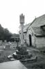 Cross stood beside church.
