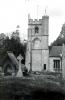 Cross beside lychgate and church.