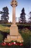 Celtic cross with wreath laid at its base