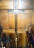 Cross fixed to wood panelling.