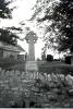 Cross with stone wall in front.