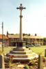 Cross and houses in the background.