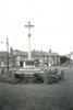 Cross and buildings in the background.