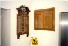 Wooden board with list of names fixed to wall.
