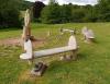 Wooden sculpture of Allied airman and surrounding benches.
